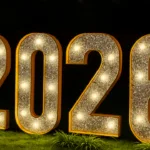 Große leuchtende Jahreszahlen 2026 als Silvesterdeko für den Außenbereich im Garten bei Nacht